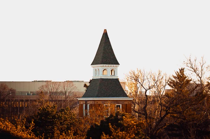 The top of Linton Hall during golden hour.
