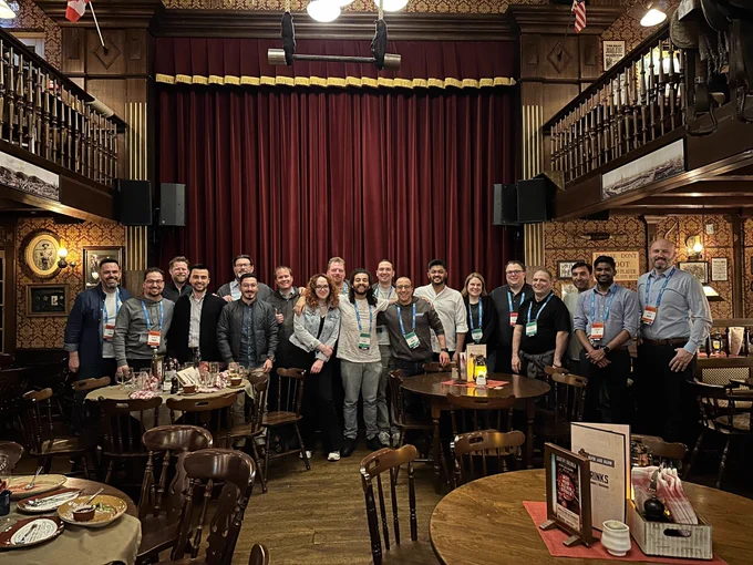 Photo at a restaurant in Europa-Park, Germany, with 19 people standing together and smiling.