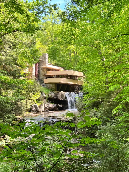 Fallingwater viewed through green leafy trees