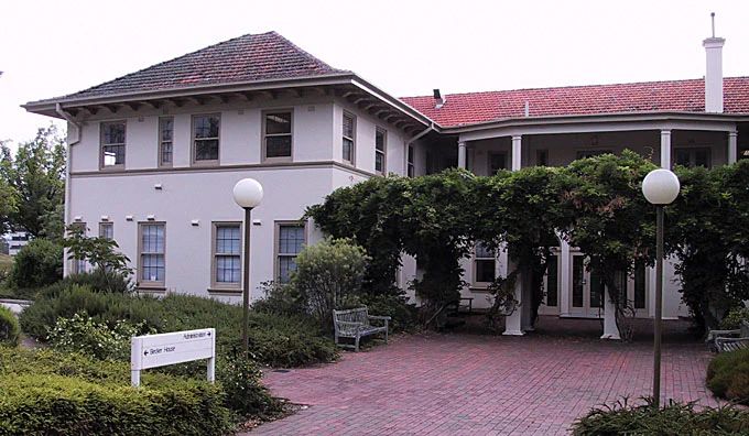 Ian Potter House is shown, a double story brick building with a large wisteria growing over the entrance. 