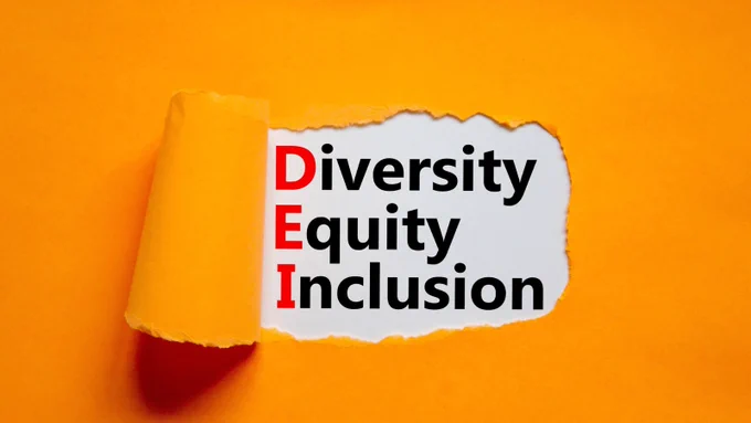 A piece of orange paper with the words Diversity Equity and Inclusion. 