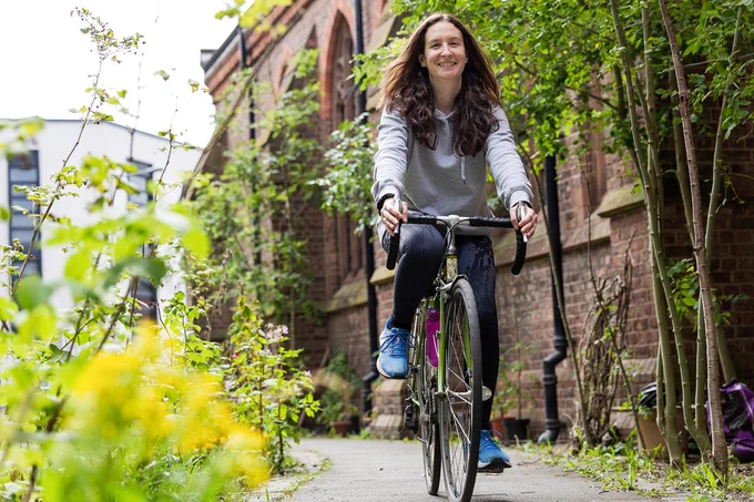 Person riding bike on off-road path wearing activewear