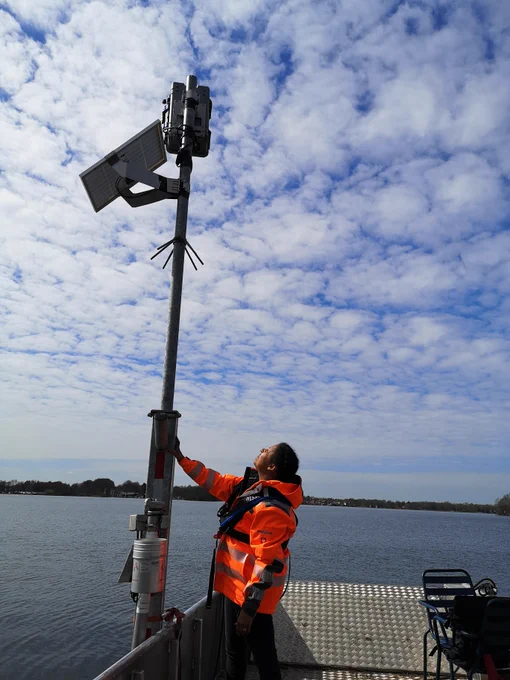 Water Insight employee checking the WISPstation installation from a boat
