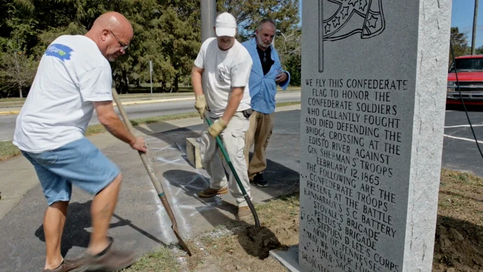 Tommy and friends digging up Confederate Monument outside The Creamery. 