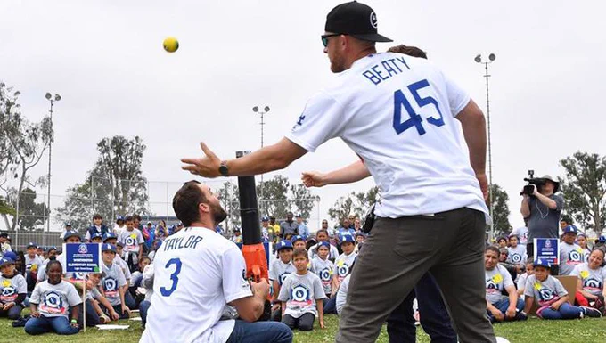Dodgers players Chris Taylor and Matt Beaty show elementary students in Inglewood, California, the importance of the launch angle. (Photo: Katie Chin/Los Angeles Dodgers)