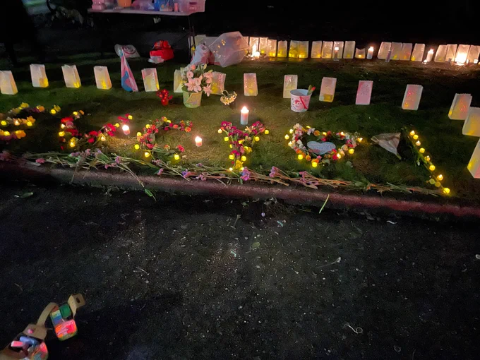 “EUCY” written in candles on the lawn surrounded by flowers 