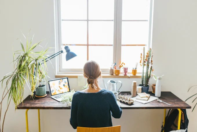 Woman sitting at a desk with her back to the camera