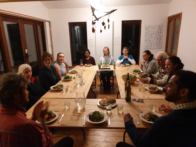 People sat around a table enjoying a communal meal