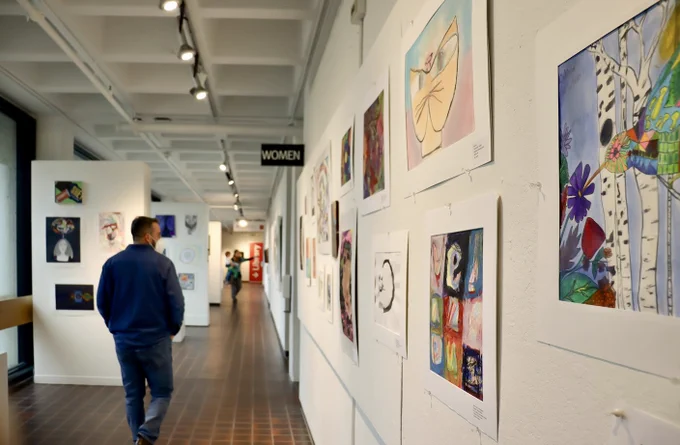 Three guests check out the Youth Art Month exhibit at the Worcester Art Museum