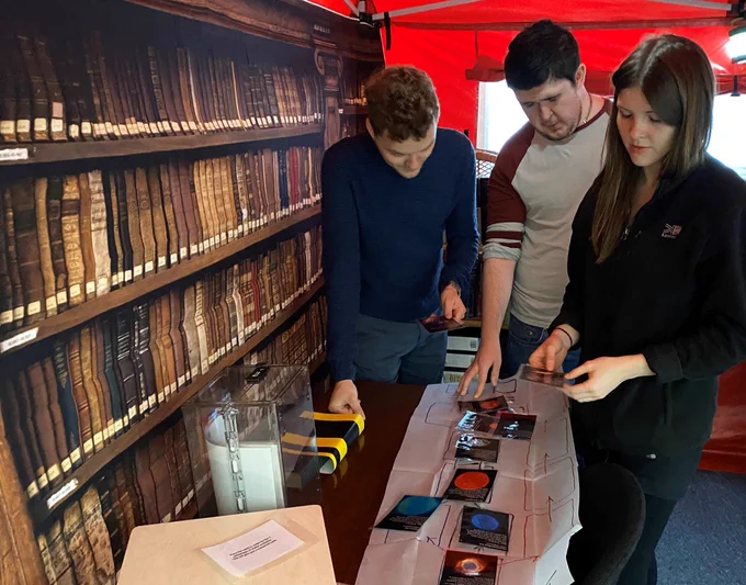 students trying to solve an escape room puzzle