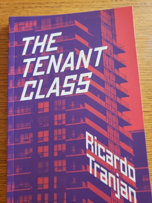 Photo of the cover of the book THE TENANT CLASS by RICARDO TRANJAN. The cover text is white, over an orange and purple image of a tall condo tower with lots of glass.
