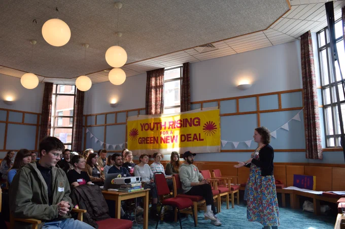 Olivia speaking to a room of GND Rising activists.