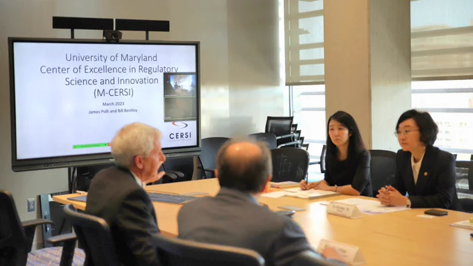 Photo of Dr. Yu-Kyoung Oh, Minister of Korea's Food and Drug Safety and colleagues discussing M-CERSI with Dr. Bill Bentley.   