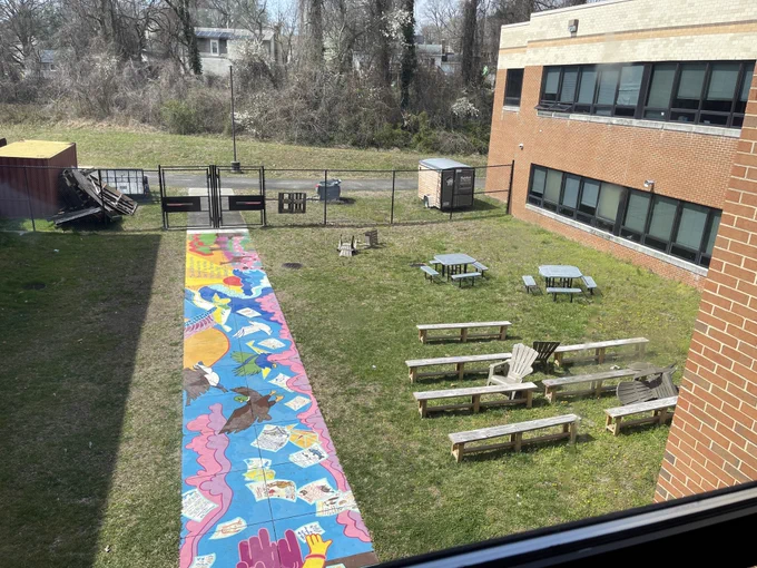 Photo of outdoor benches and a colorfully painted sidewalk at Broadneck High School.