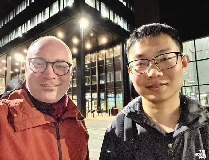 Dr Xinye Chen, who just passed his PhD viva, with supervisor in front of the University of Manchester's new Engineering Campus MECD