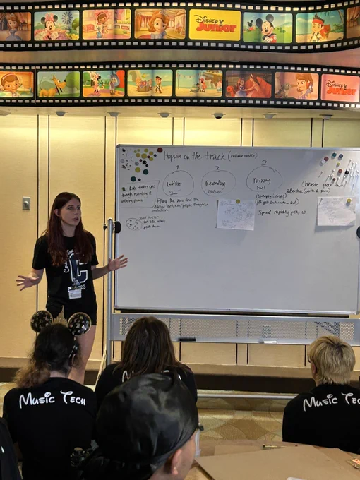 Student presenting in front of a white board