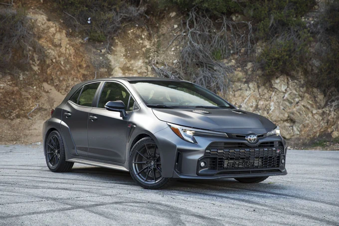 The GR Corolla Morizo, a grey performance hatchback, parked askew on a gravel road