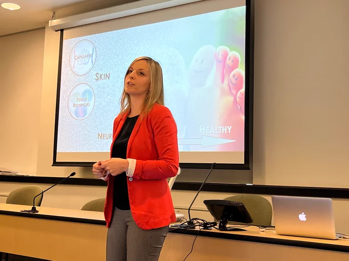 A photograph of Erika presenting in the 3MT competition.