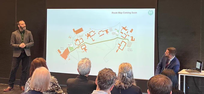 David Livermore presenting AccessAble’s Route Map design to an audience. On screen is a portion of the University Park Campus map with a route and several key buildings highlighted.