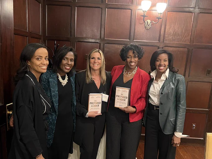From left, Meriem Soliman, Lynn Perry Wooten, Jeannine Sommer, Denielle Pemberton-Heard and Erika James stand and pose for the camera. Jeannine and Denielle hold copies of "The Prepared Leader."
