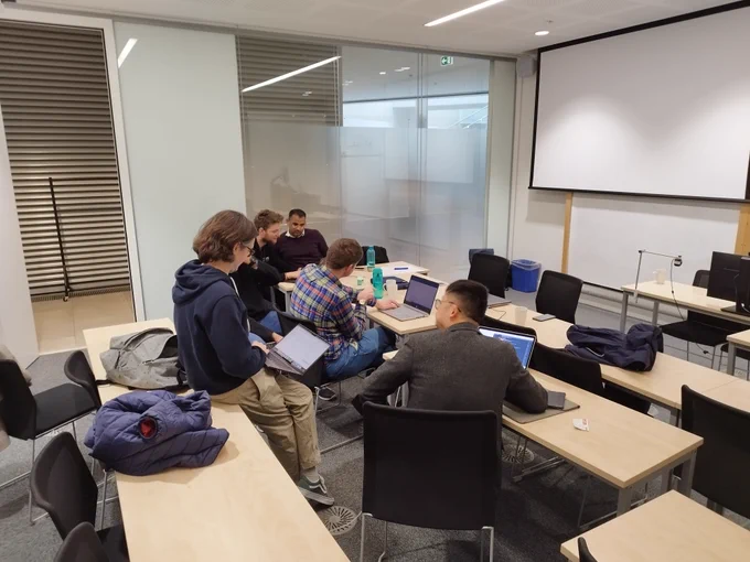One of the groups working together in a classroom.
