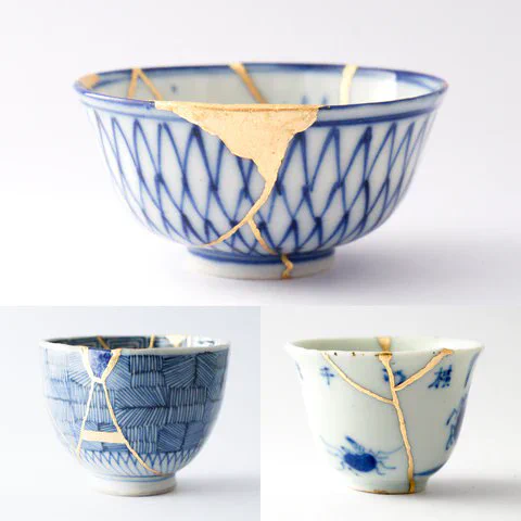 3 bowls that have been repaired using the Kintsugi method of golden paint glue. 
