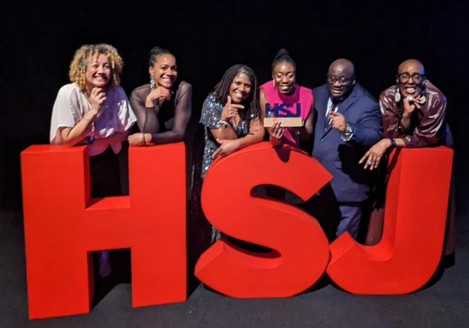 Together’s Culturally Appropriate Peer Support and Advocacy service team with giant HSJ letters at award ceremony