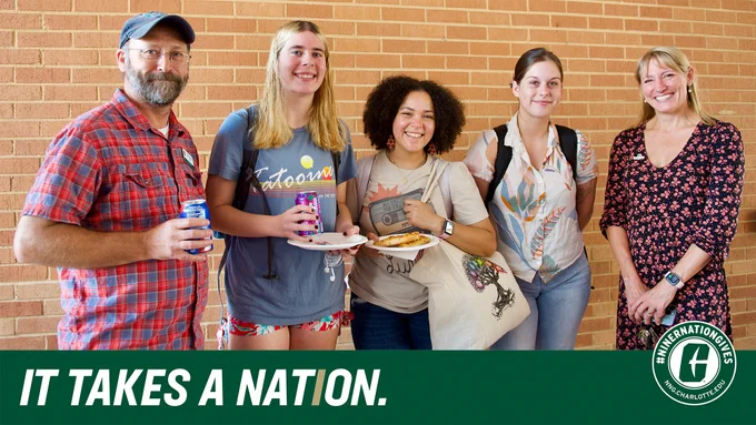 Five people - students and faculty from History Department, holding sodas and pizza