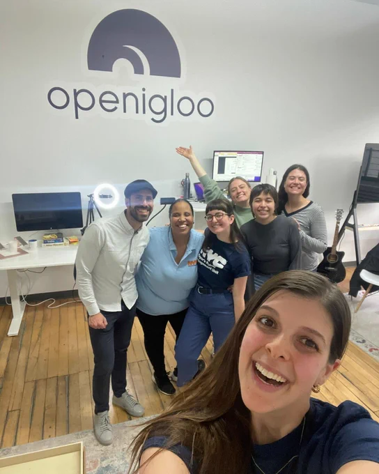 Selfie of Public Engagement Unit and open igloo staff in an office with an open igloo sign on the wall behind them