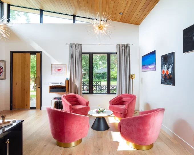 modern living room with four pink chairs