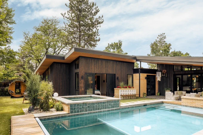 rear exterior of modern home with pool and spa