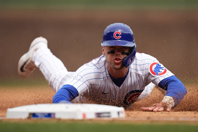 Nico Hoerner slides into third base safely.