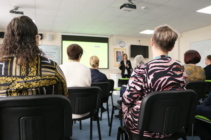 Photo of TeamQEH members attending the AccessAble launch event with Anna Nelson, AccessAble Chief Executive presenting