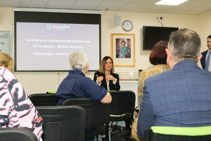 Photo of TeamQEH members attending the AccessAble launch event with Anna Nelson, AccessAble Chief Executive presenting