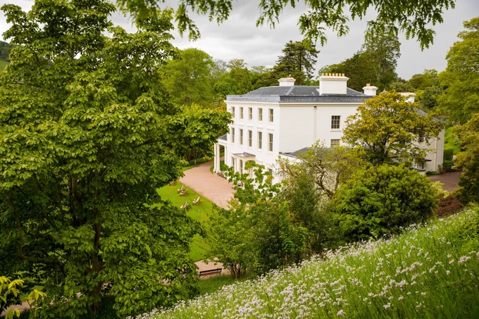 Photograph of Greenway house through the trees (Image: National Trust)