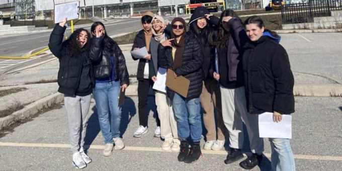 Students in a parking lot.