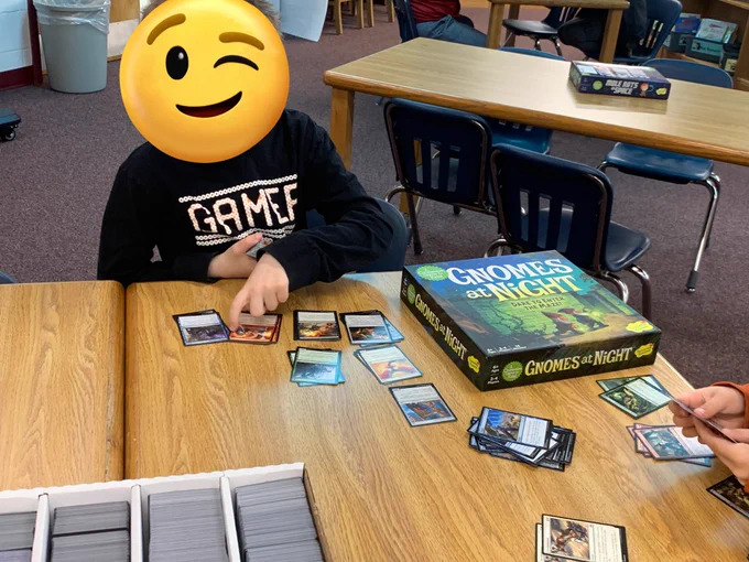 Student sorting Magic the Gathering cards