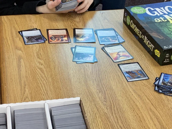 Student categorizes Magic the Gathering cards.
