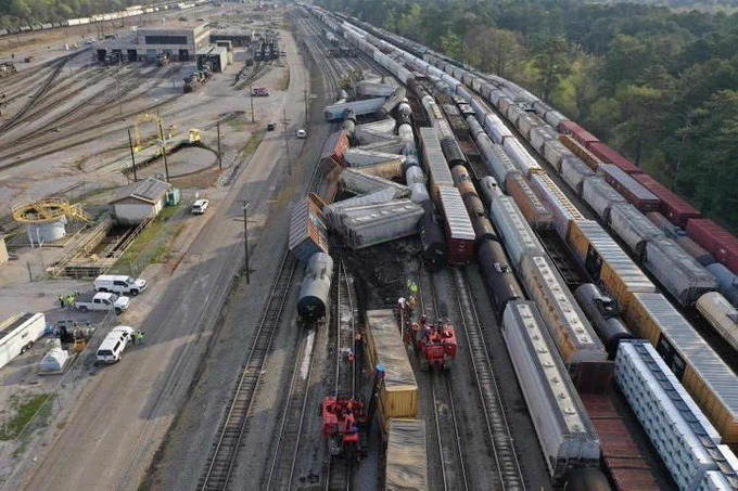 Train derailment of about 15 cars plus additional adjacent cars in Norris railyard Irondale, Alabama. The rail cars are seen accordioned almost 90° with the rail.