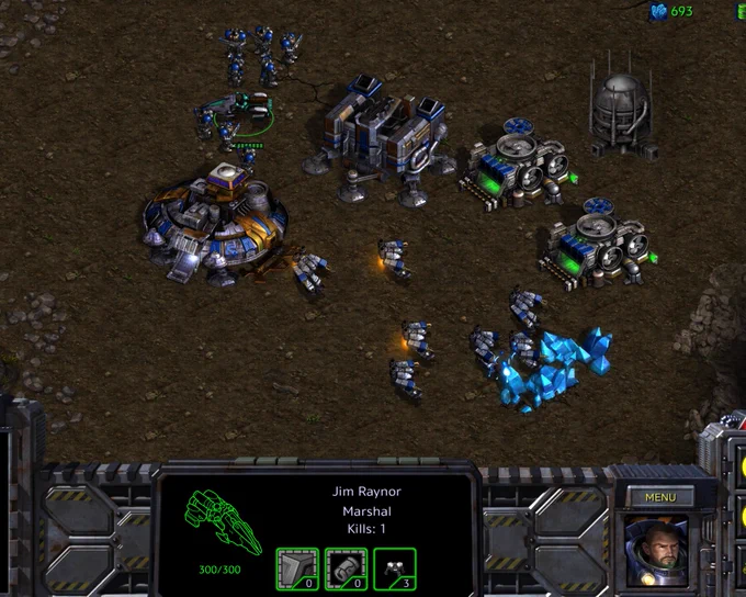 Image of a StarCraft Terran base with a Command Center surrounded by SCV mineral line, eight marines and Jim Raynor