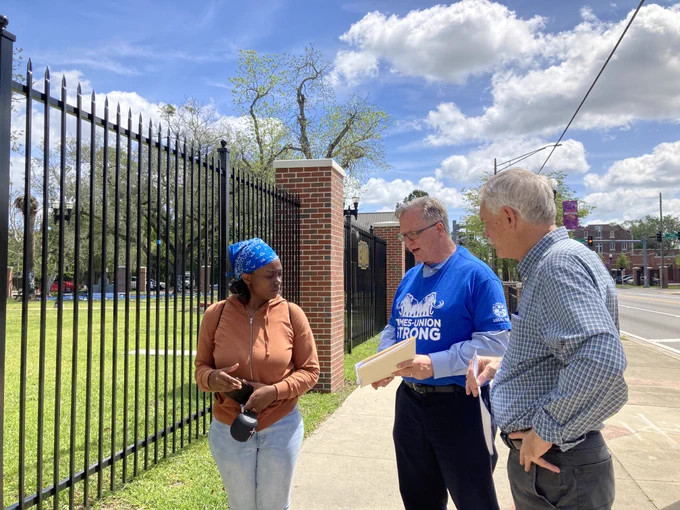 Florida Times-Union journalists David Bauerlein and Bob Self speak with a community member about ongoing contract negotiations for guild members near Edward waters University.