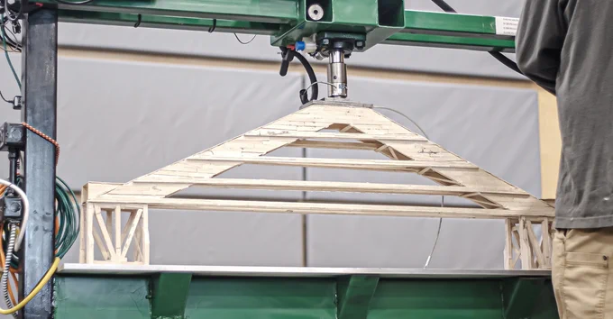 The winning middle school bridge design undergoing its weight test.