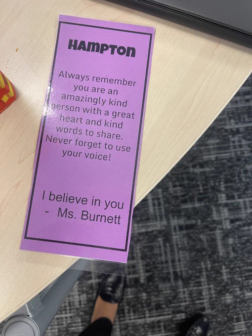 Photograph of a laminated purple bookmark with the text "Hampton: Always remember you are an amazingly kind person with a great heart and kind words to share. Never forget to use your voice! I believe in you. – Ms. Burnett"