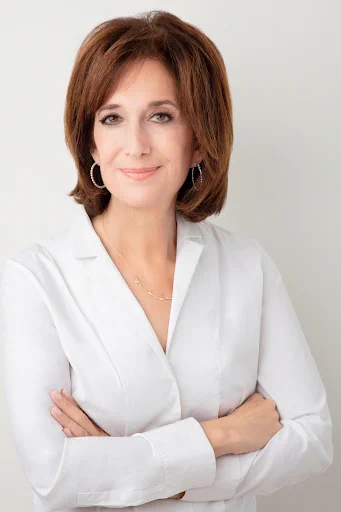 A professional headshot of Sue Jacobson.
