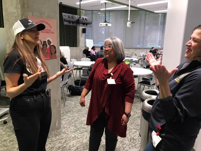 Shireen Hafeez of Deaf Kids Code, Tina Childress, audiologist and tech extraordinaire and MOPD Commissioner Rachel Arfa are talking animatedly.