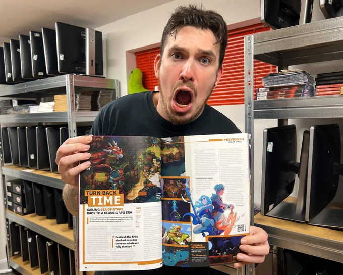 A shocked man holds a copy of Debug magazine, featuring an article about the video game Sea of Stars.