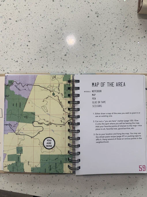 Image of a book that says map of the area that says to put maps with stickers saying you are here