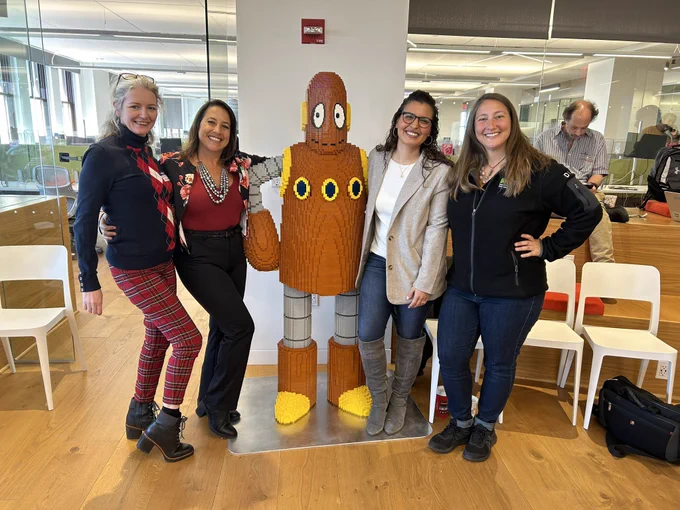 Jenny, Lisa, Laura, and Gina posing with Moby from BrainPOP, who is made entirely of Lego pieces.