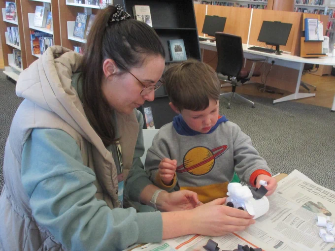 adult and child making spring lamb from recycled materials