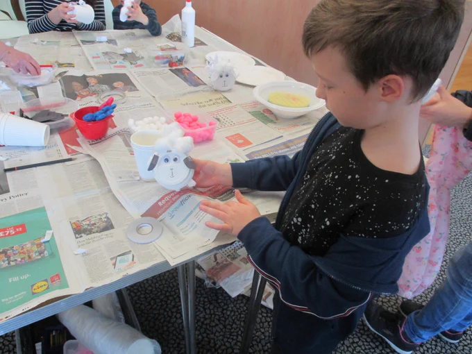 boy making a lamb from recycled materials